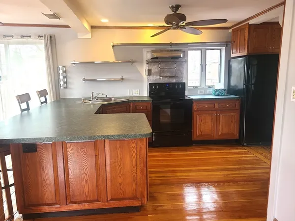 a kitchen with stainless steel appliances granite countertop a sink and a stove