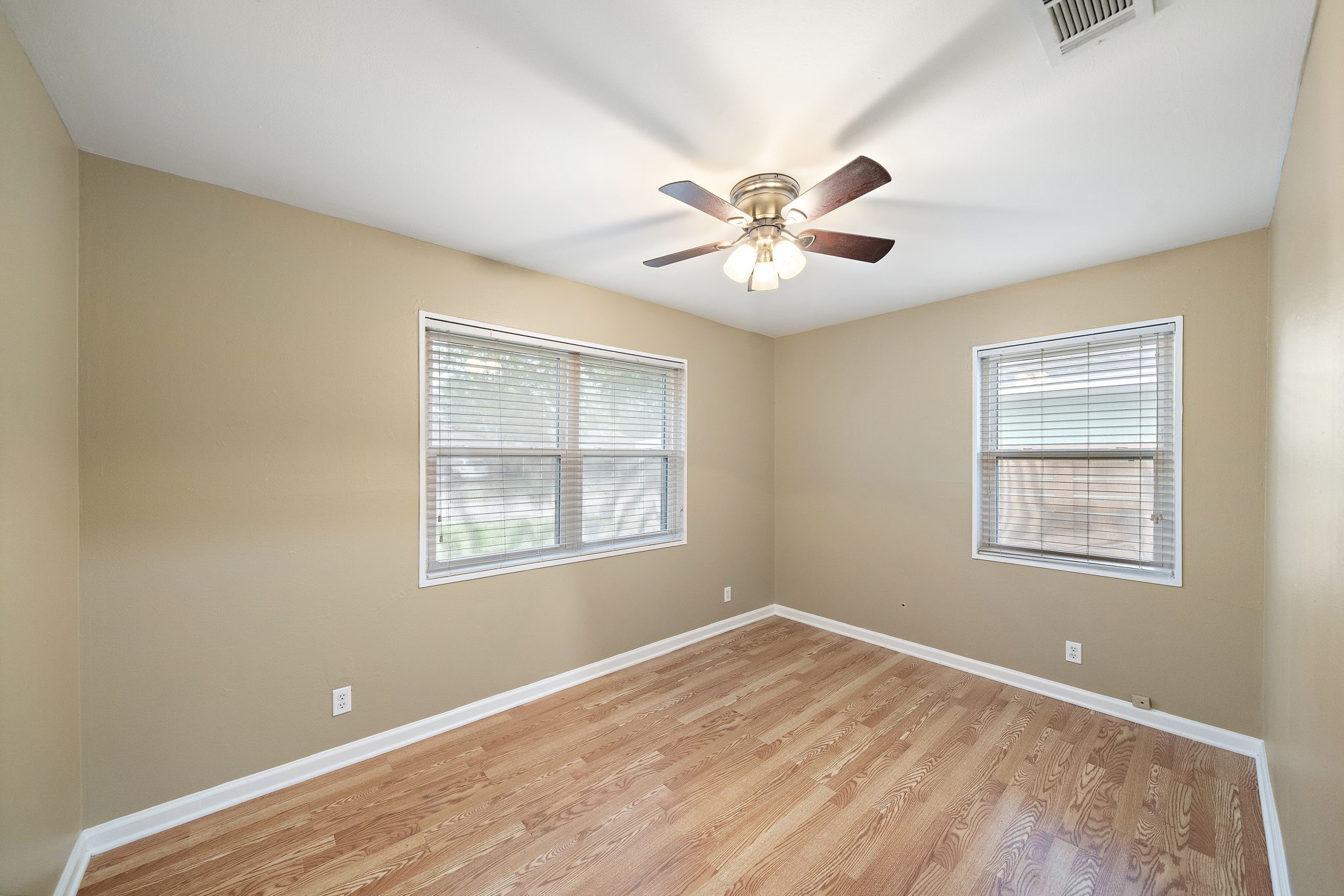 6523 Underhill Street Houston, TX 77092 - Photo 4 of 11 a view of an empty room with a window and wooden floor
