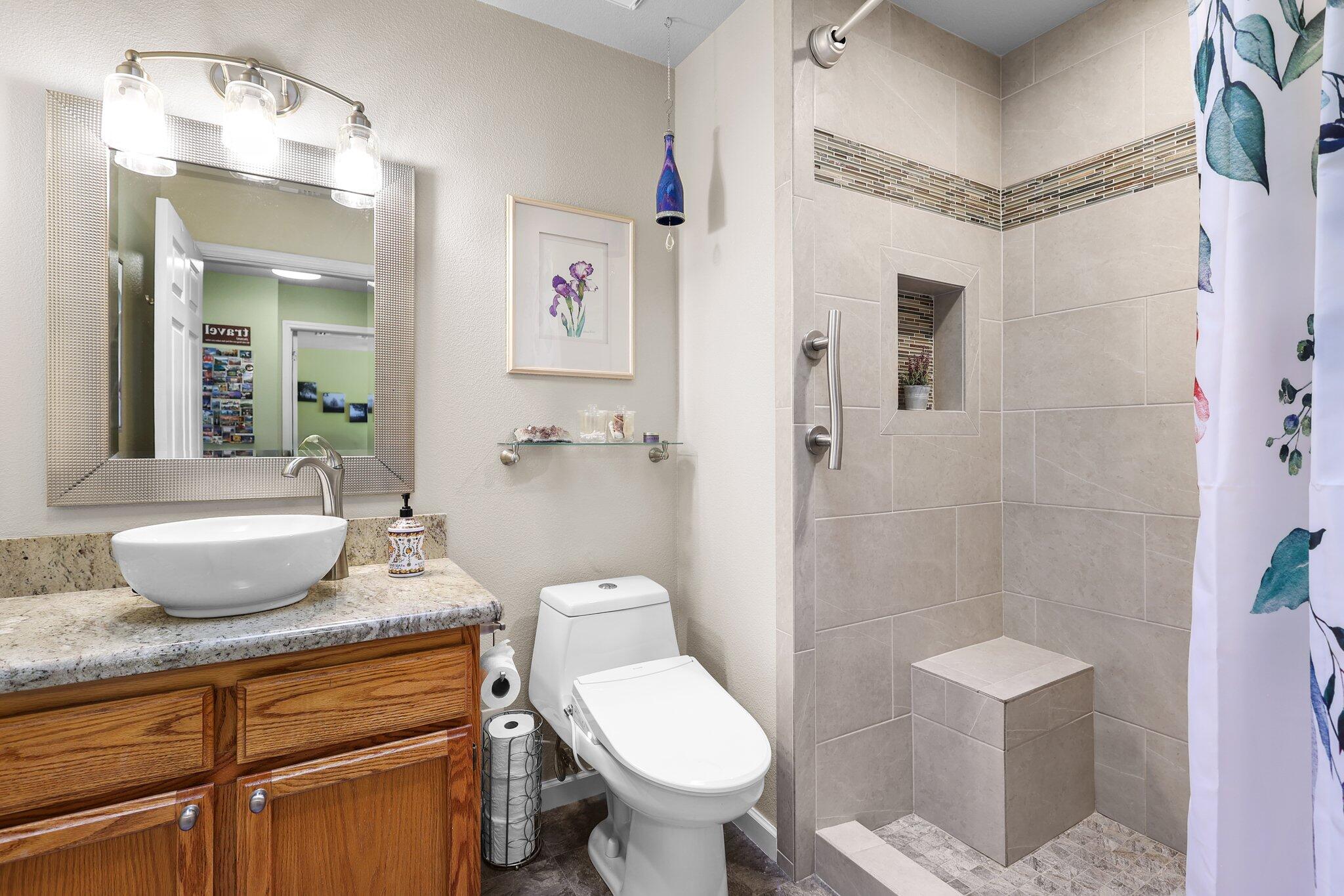 2788 Summerbreeze Place Redding, CA 96001 - Photo 18 of 28 a bathroom with a granite countertop sink toilet a mirror and shower