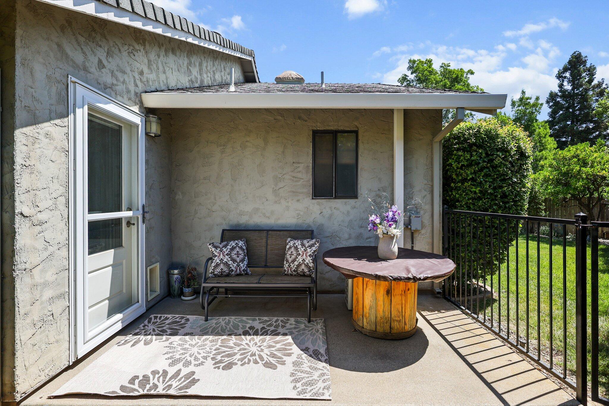 2788 Summerbreeze Place Redding, CA 96001 - Photo 22 of 28 a view of a patio with table and chairs potted plants with wooden floor and fence