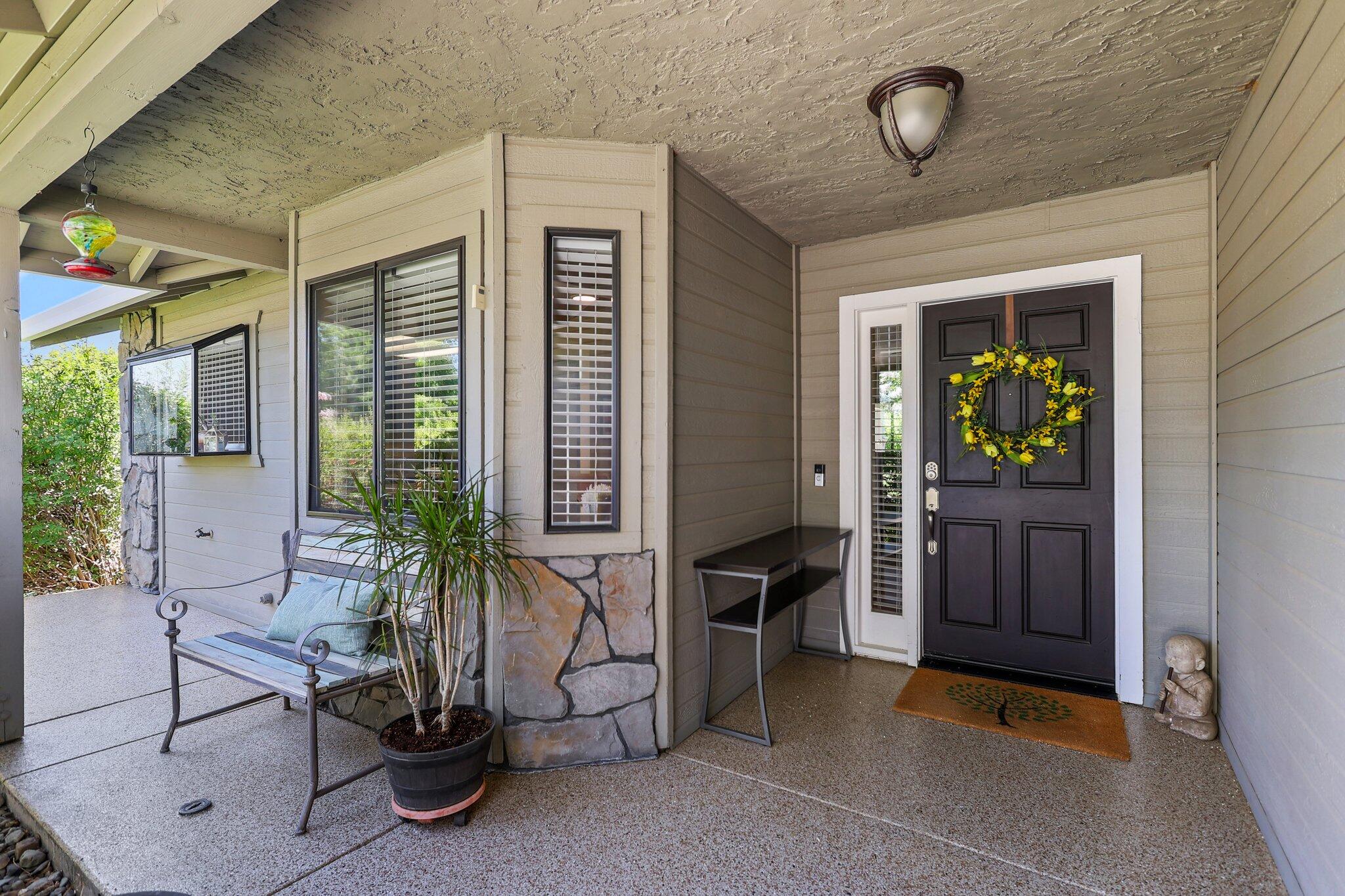 2788 Summerbreeze Place Redding, CA 96001 - Photo 3 of 28 a hallway with a table and a potted plant