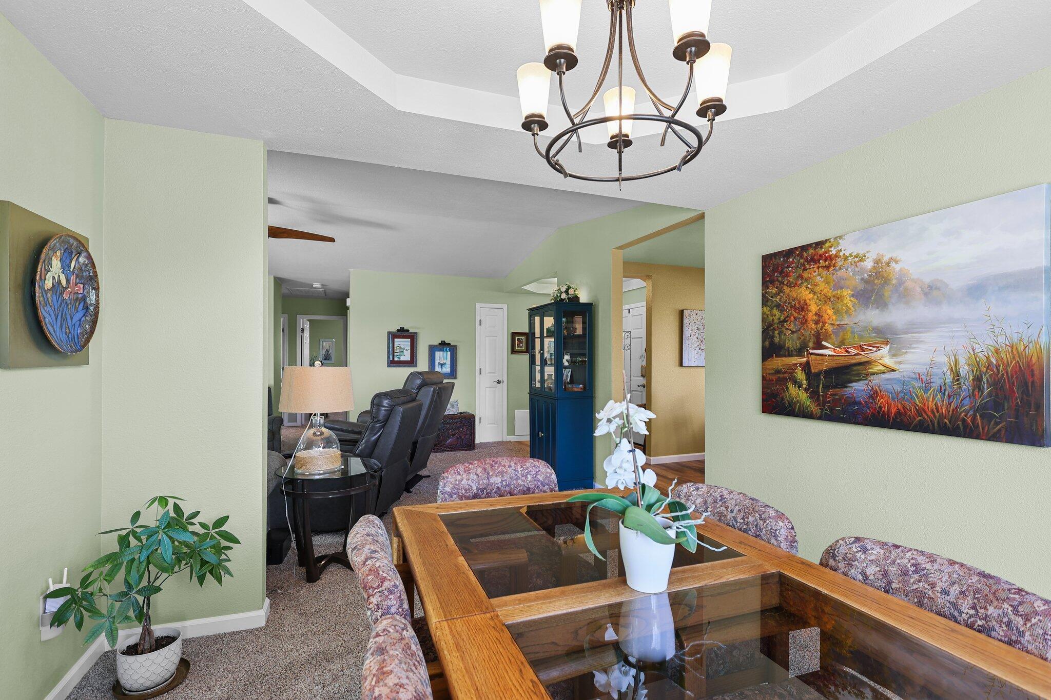 2788 Summerbreeze Place Redding, CA 96001 - Photo 9 of 28 a living room with furniture a dining table and paintings on the wall