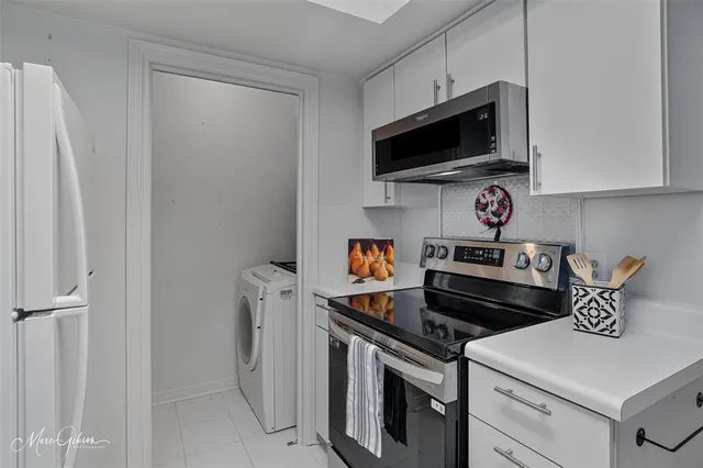 a kitchen with a sink a stove and cabinets