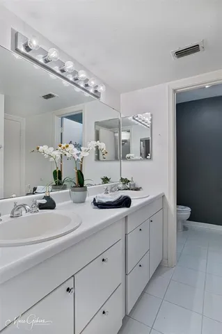 a bathroom with a double vanity sink and mirror