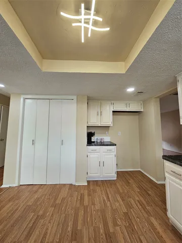 a kitchen with a wooden floor and window