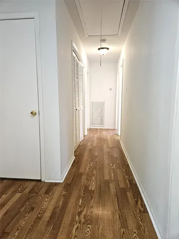 a view of a hallway with a chandelier