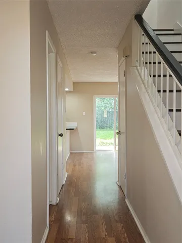 a view of hallway with wooden floor