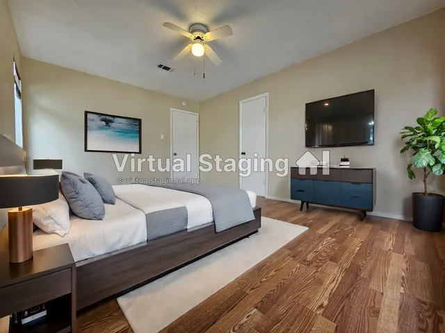 a bedroom with a bed and a flat screen tv