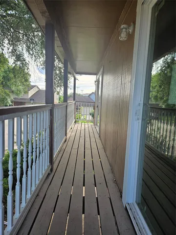 a view of balcony with wooden floor