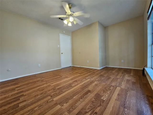 a view of an empty room and wooden floor