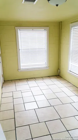 a view of an empty room and a window