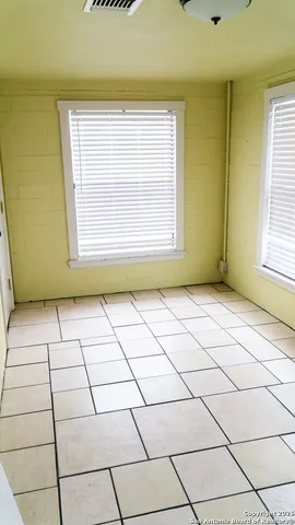 a view of an empty room and a window