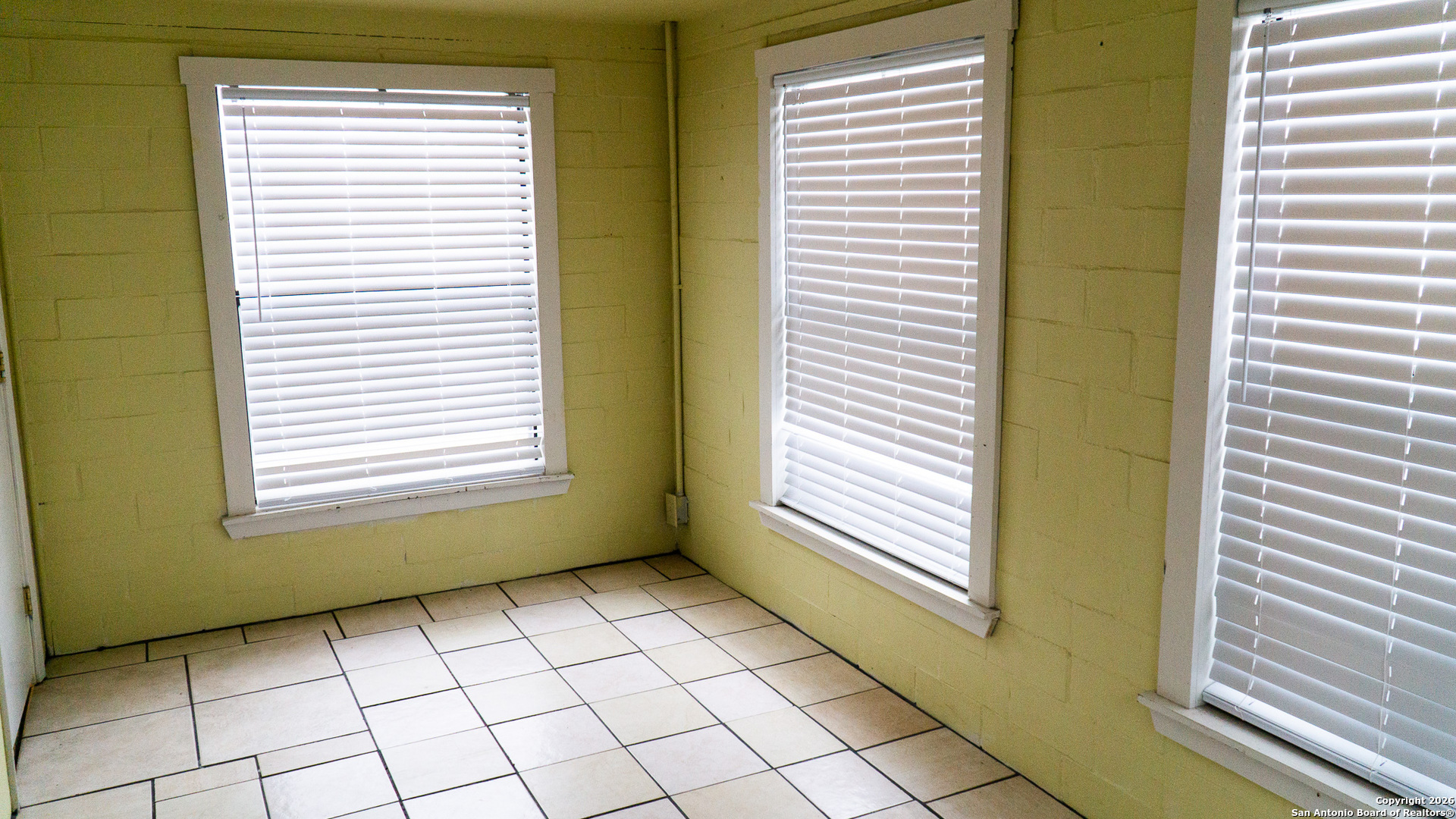 730 Main Street Utopia, TX 78884 - Photo 18 of 23 a view of an empty room with a window and a chair