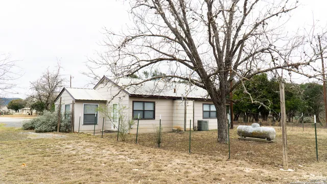 a backyard of a house with table and chairs