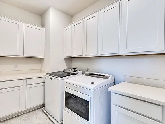 10403 Bramble Berry Drive Austin, TX 78748 - Photo 18 of 21 a view of cabinets with washer and dryer