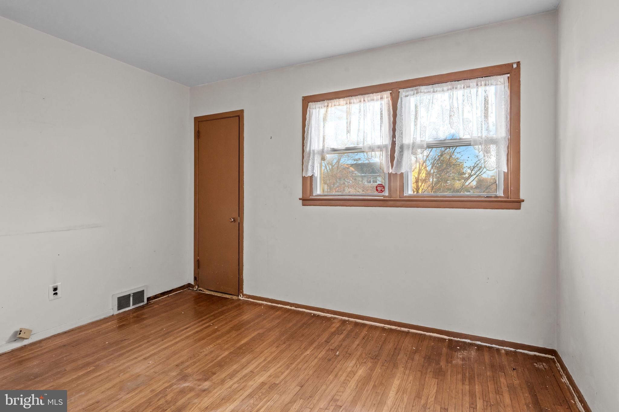 3723 Ridgewood Lane Brookhaven, PA 19015 - Photo 4 of 22 an empty room with wooden floor and windows