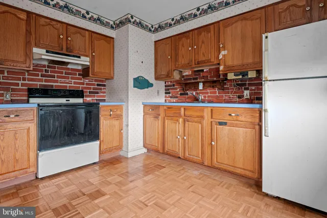 a kitchen with stainless steel appliances a stove a sink and a refrigerator