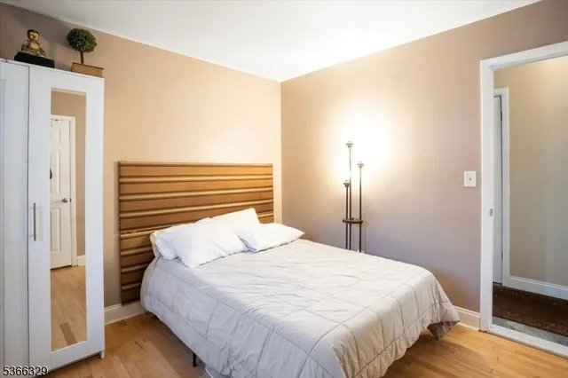 a bedroom with a bed and a mirror