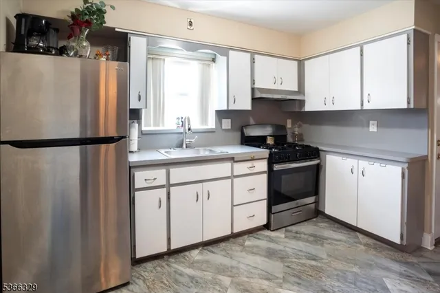 a kitchen with stainless steel appliances granite countertop a refrigerator sink and cabinets