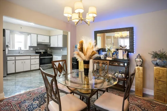 a view of a dining room with furniture and a chandelier