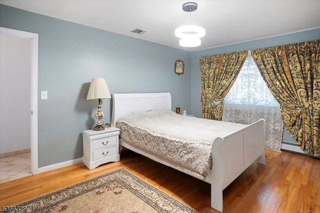 a bed sitting in a room next to a window