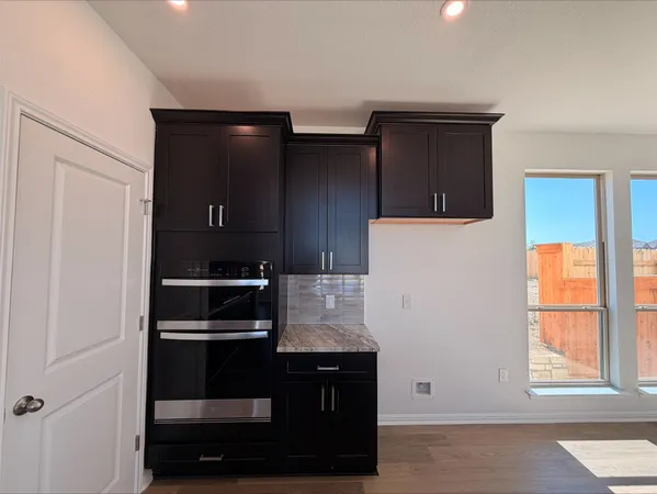 a kitchen with a refrigerator and window