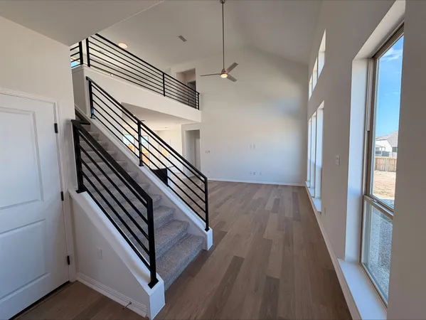 a view of entryway and hall with wooden floor