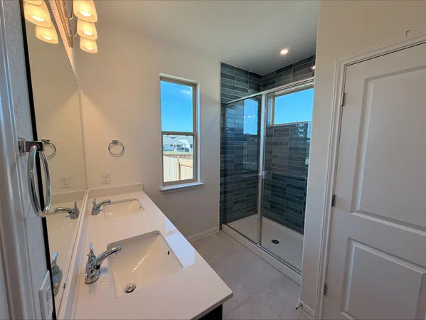 a bathroom with a tub sink and mirror