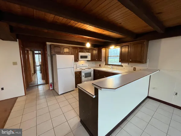 a kitchen with cabinets and stainless steel appliances