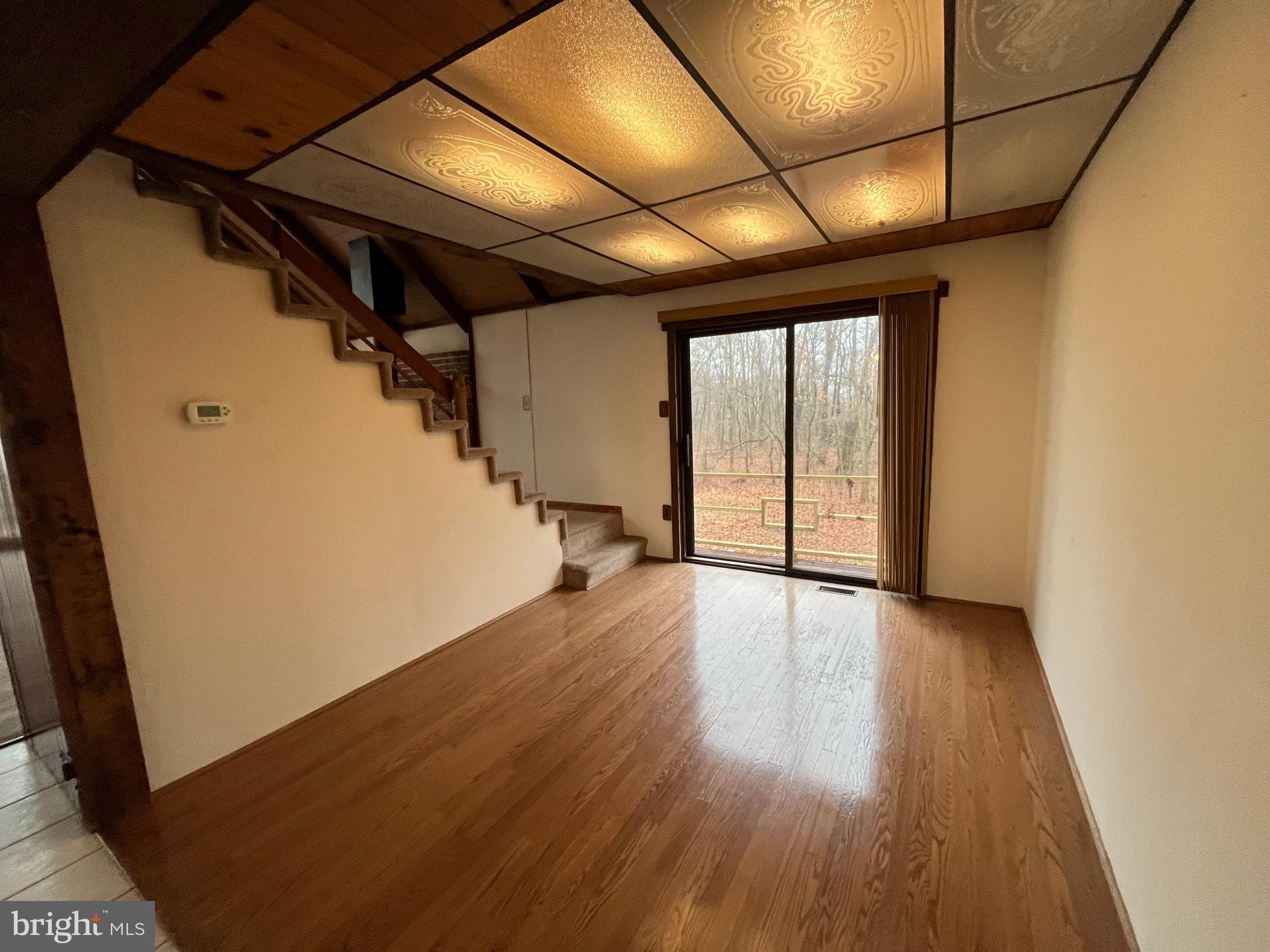 191 Rattlesnake Hill Road Boyertown, PA 19512 - Photo 5 of 9 a view of an empty room with wooden floor and staircase