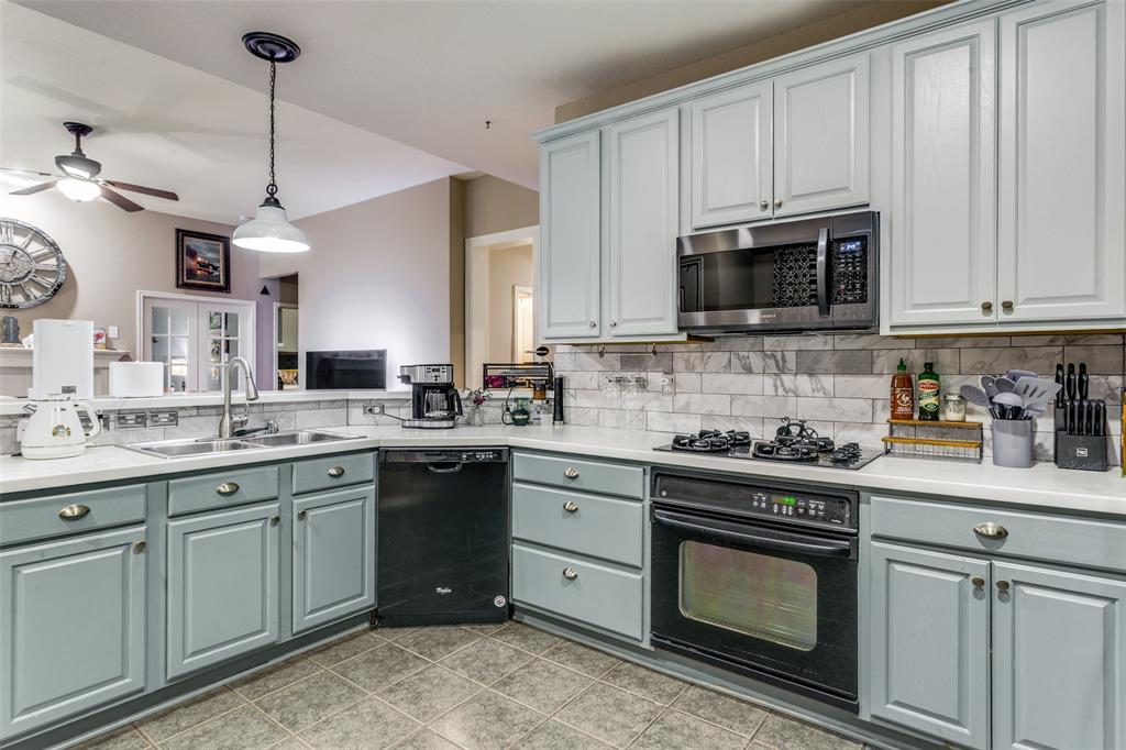 9117 Ripley Street Fort Worth, TX 76244 - Photo 11 of 35 Kitchen featuring light blue cabinetry with brushed nickel hardware, white countertops, and a subway tile backsplash