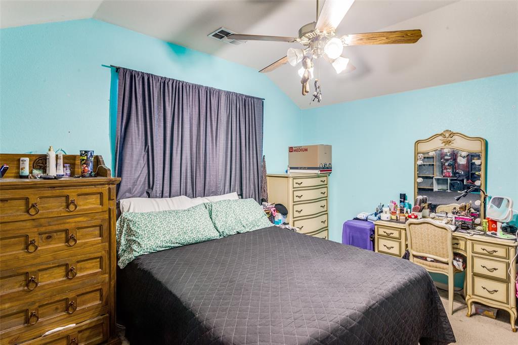 9117 Ripley Street Fort Worth, TX 76244 - Photo 19 of 35 Vaulted ceiling bedroom featuring a ceiling fan with light fixture and a window with dark drapery