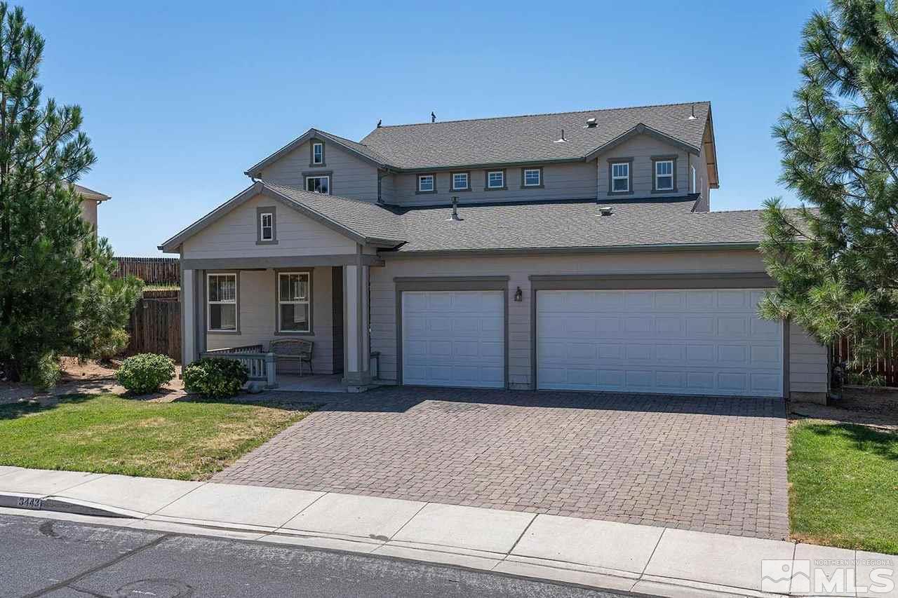 3443 Weaver Place Reno, NV 89512 - Photo 1 of 23 a front view of a house with a yard and garage
