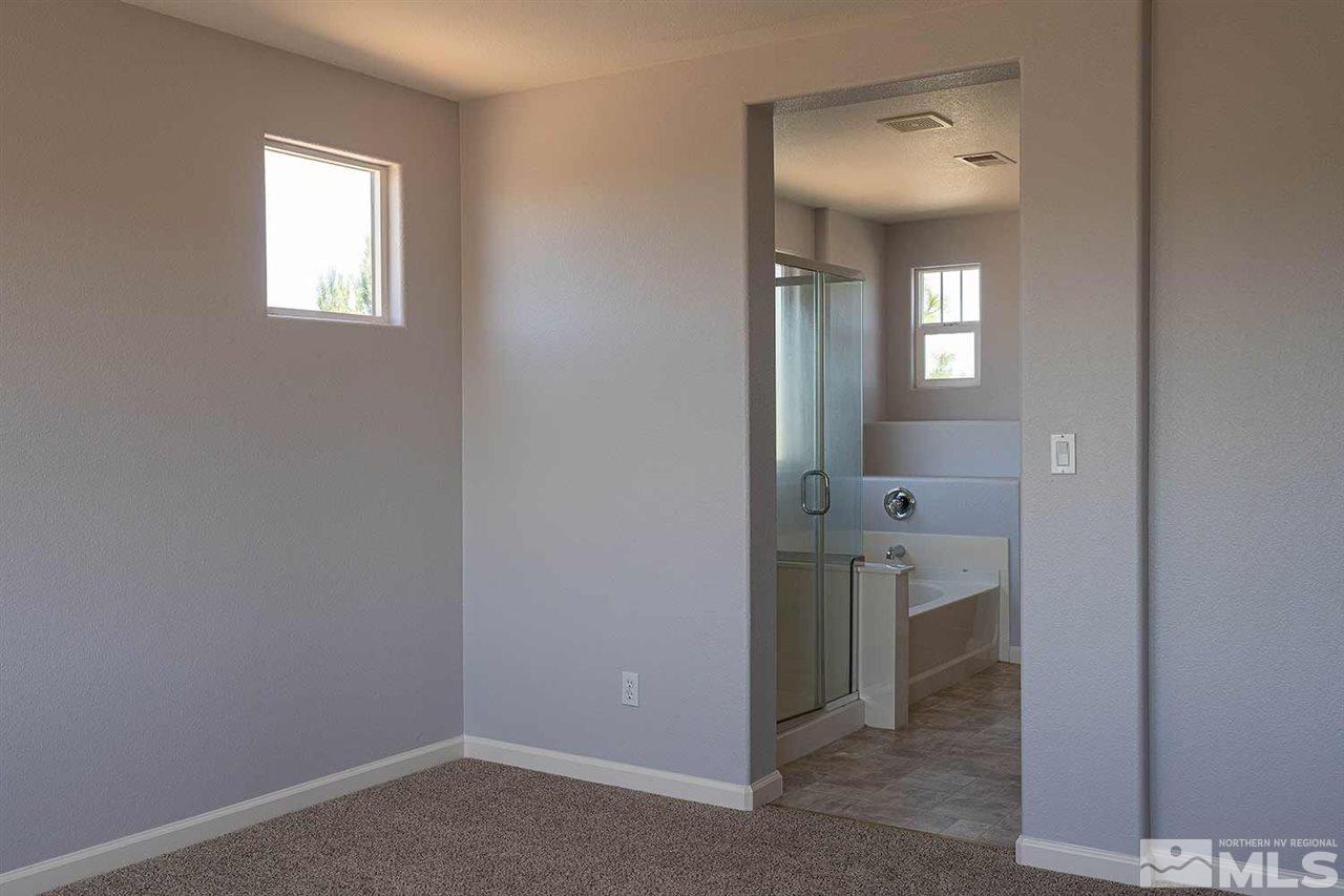 3443 Weaver Place Reno, NV 89512 - Photo 16 of 23 a view of a bathroom from a hallway with windows and a bathroom
