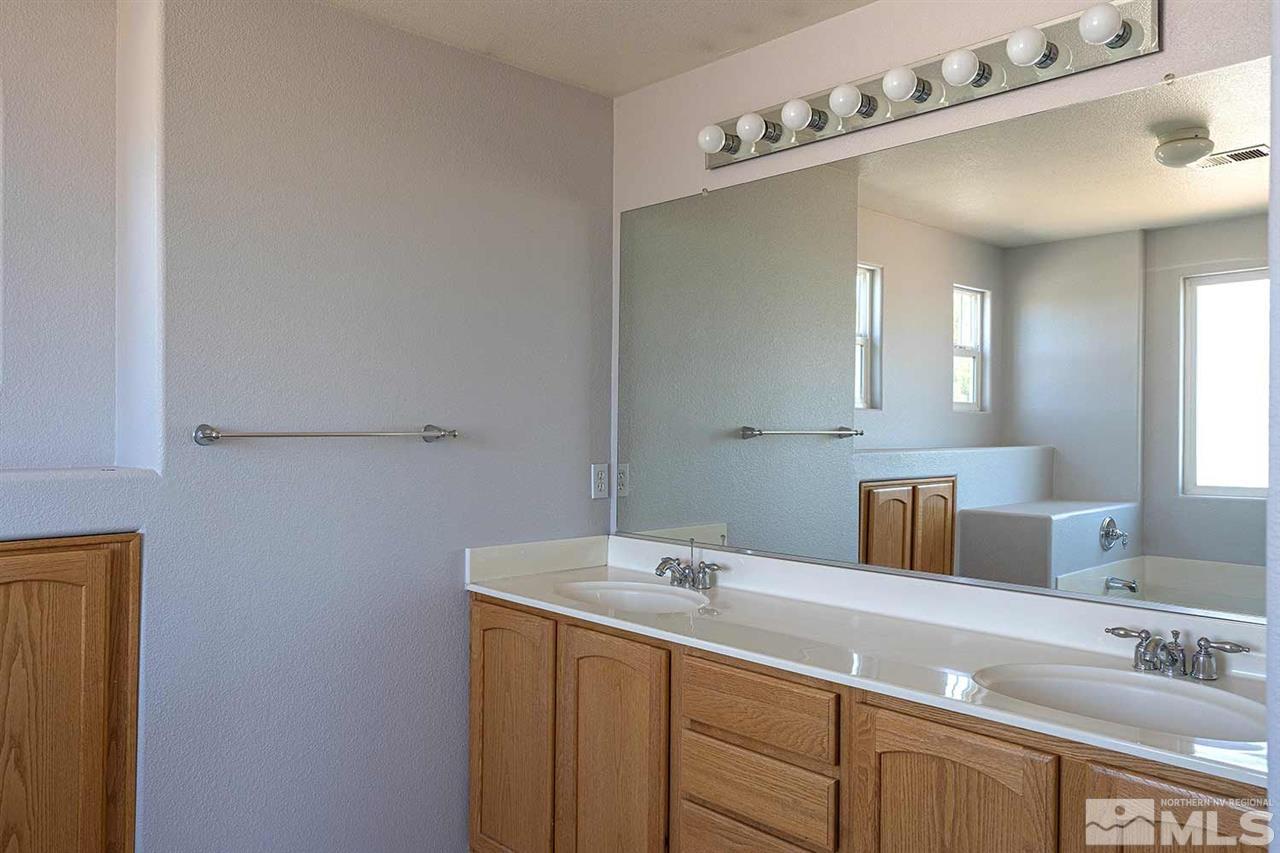 3443 Weaver Place Reno, NV 89512 - Photo 17 of 23 a bathroom with a sink and a mirror