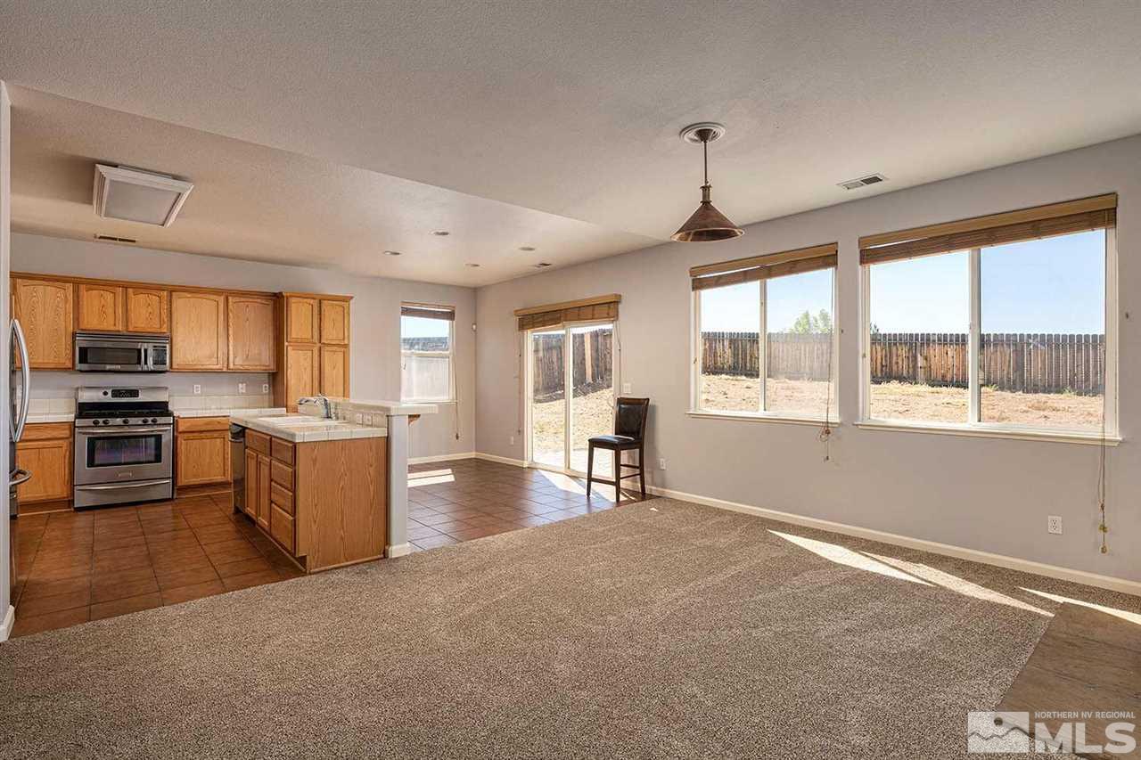 3443 Weaver Place Reno, NV 89512 - Photo 3 of 23 a open kitchen with stainless steel appliances granite countertop a stove and a refrigerator