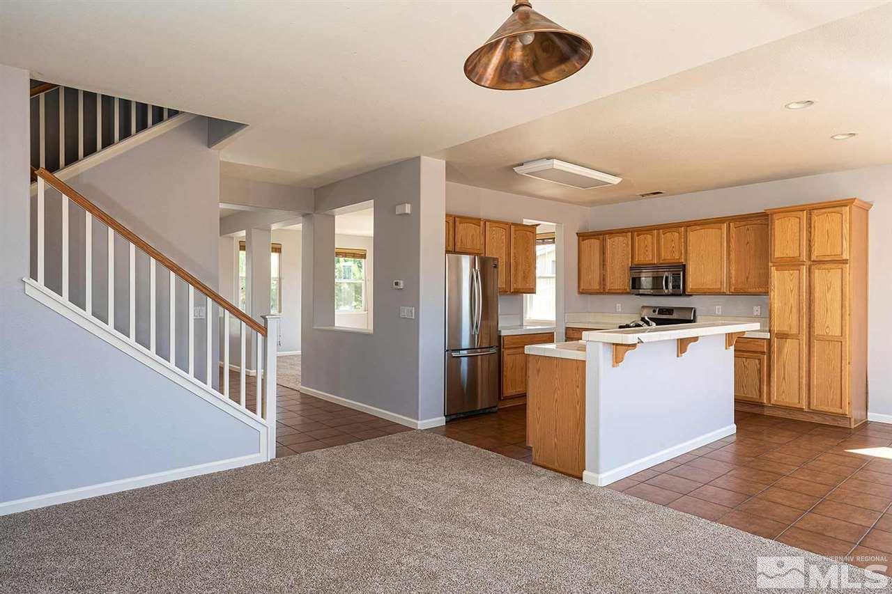 3443 Weaver Place Reno, NV 89512 - Photo 4 of 23 a kitchen with refrigerator and cabinets