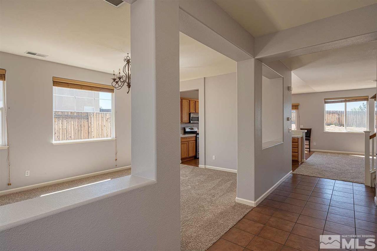 3443 Weaver Place Reno, NV 89512 - Photo 8 of 23 a view of a hallway with wooden floor and a living room