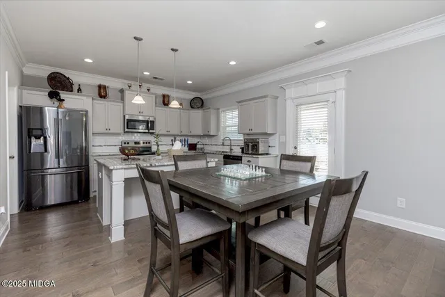 a bathroom with a sink a toilet a mirror and shower curtain