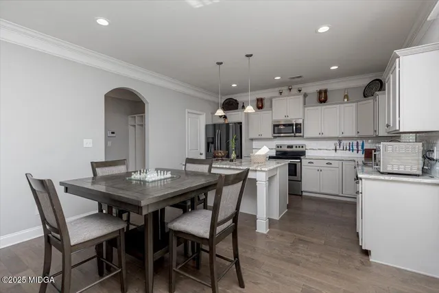 a bedroom with a bed and a dresser in it