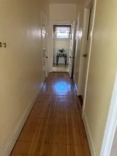 a view of a room with wooden floor and staircase