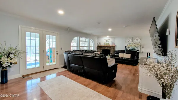 a large kitchen with kitchen island a large counter top space a sink stainless steel appliances and cabinets