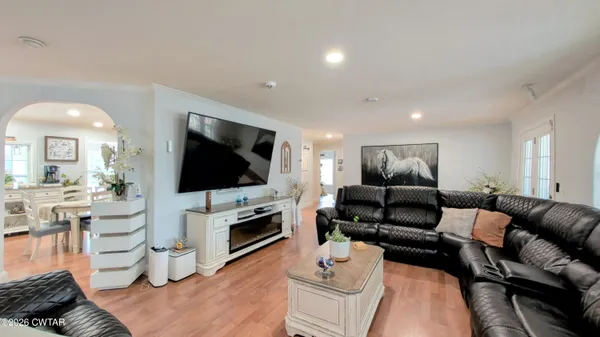 a kitchen with kitchen island stainless steel appliances sink cabinets dining table and chairs