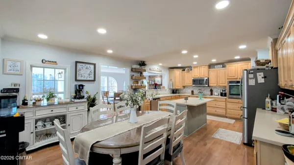 a large kitchen with kitchen island a sink table and chairs