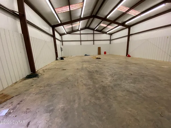 a front view of a house with a garden and yard