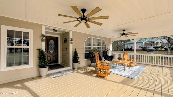 a spacious bedroom with a bed and wooden floor