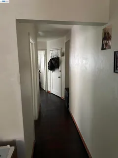 a view of empty room with window and ceiling fan