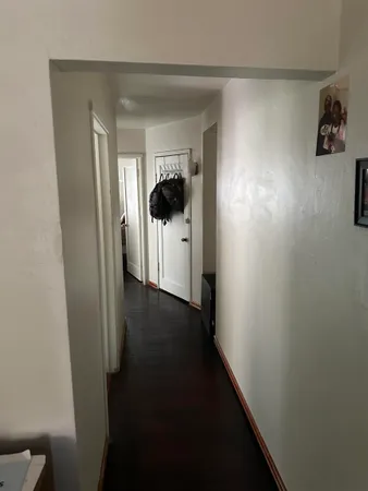 a view of empty room with window and ceiling fan