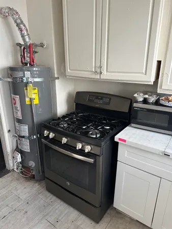 a kitchen with a stove a sink and a refrigerator