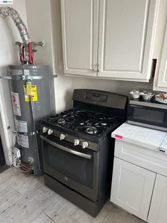 a kitchen with a stove a sink and a window
